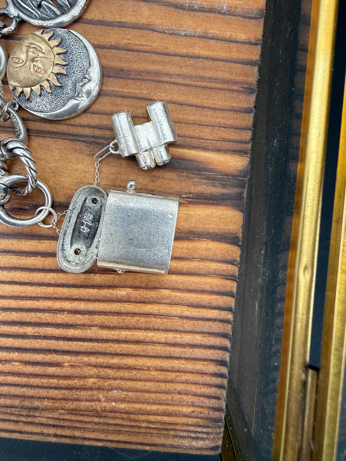 Binoculars charm, shown on a charm bracelet