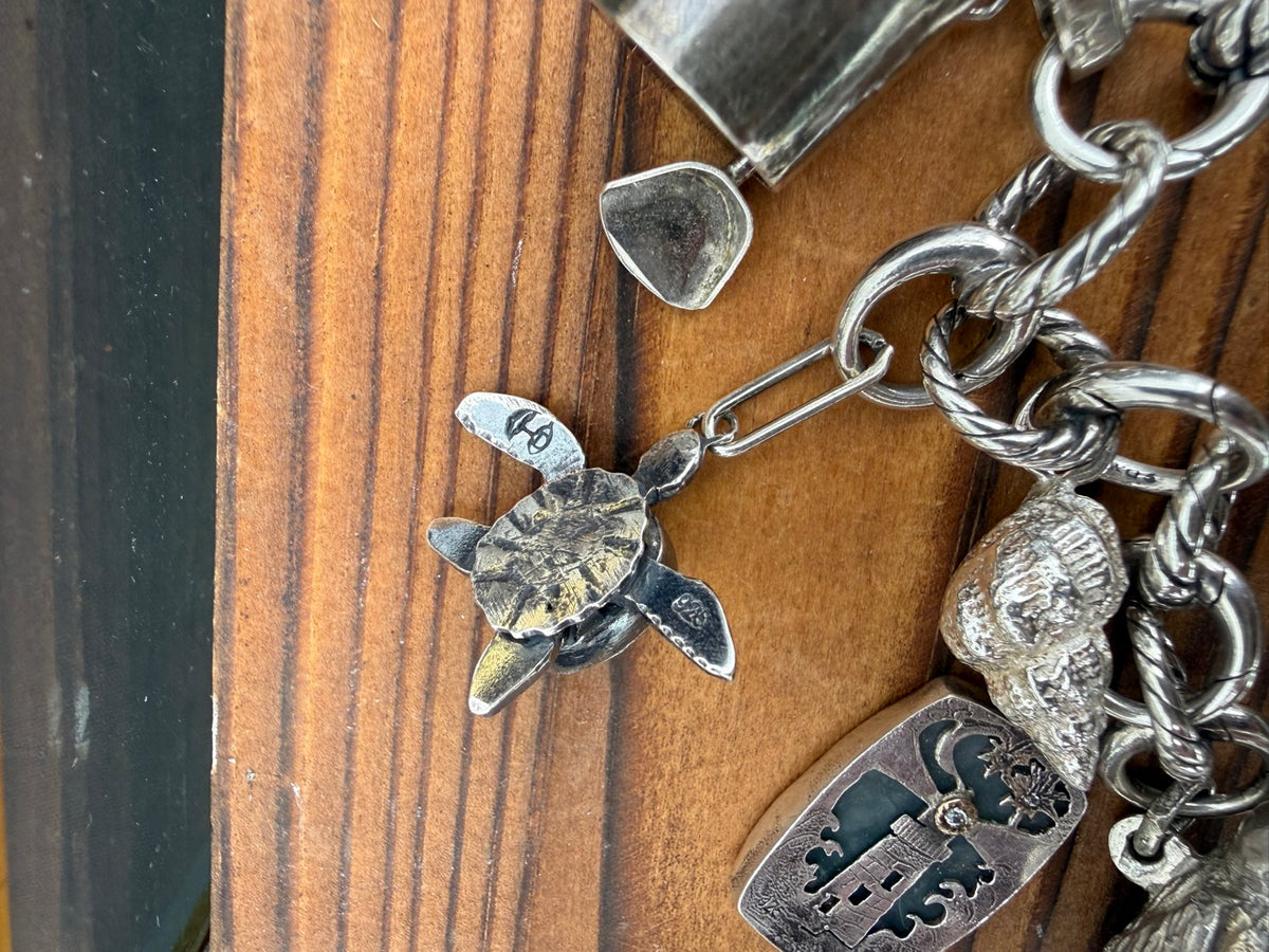Underside of the articulated green onyx turtle charm, showing the moving flippers