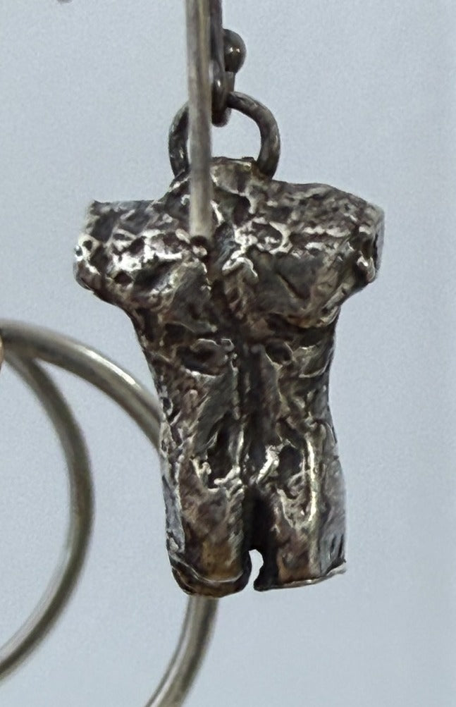Male torso earring, back view, second angle