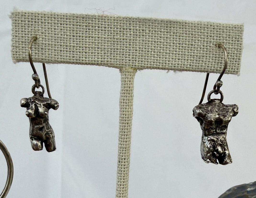 Sterling silver male and female torso earrings on a stand